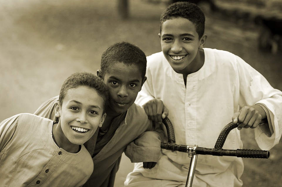 Three brothers smiling at the camera.